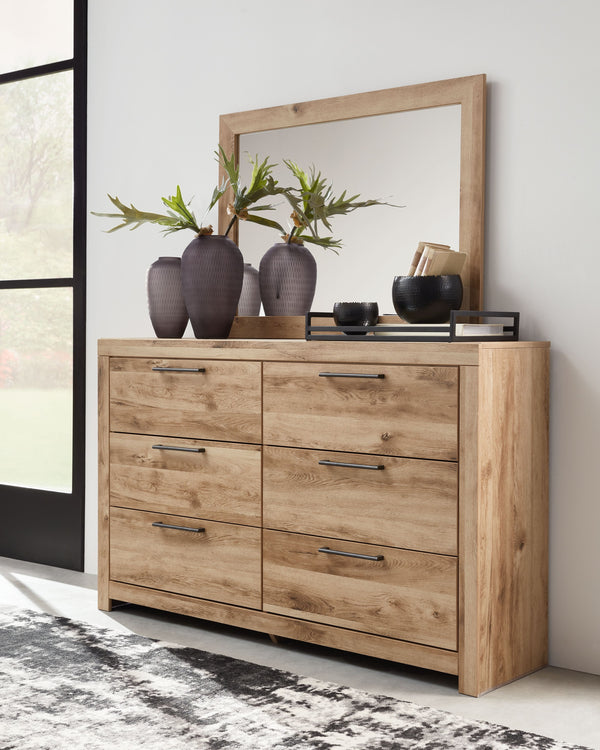 Inspired by natural beauty, refined to perfection. This dresser with mirror brings cozy outdoor vibes to your bedroom with its warm and inviting golden rustic finish. Antiqued gunmetal handles adorn the six drawers on its framed front, adding an industria
