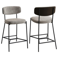 Introduce comfort and style with a set of two contemporary counter stools for your kitchen. Each features a black finish metal frame, offering streamlined character with slim structure and geometric details. Light, neutral upholstery covers foam cushions,