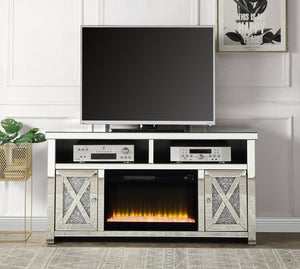 Brighten up your living space with the Noralie TV stand with a fireplace. In an alluring mirrored and faux diamond finish to showcase your glamourous side. The media shelf has cable management cutouts to keep cables out of sight to preserve the beautiful 