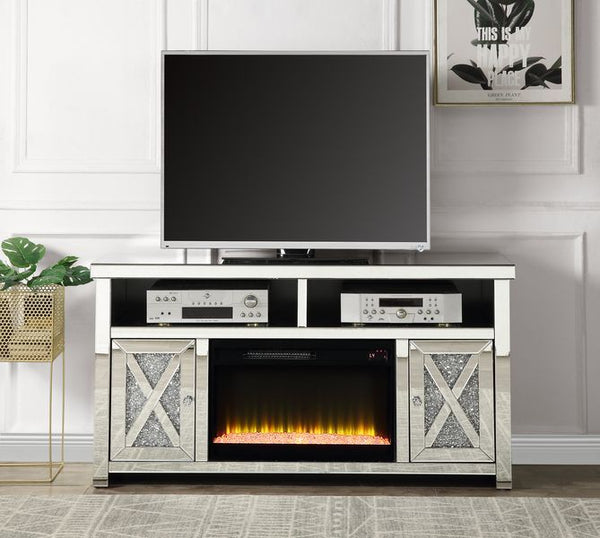 Brighten up your living space with the Noralie TV stand with a fireplace. In an alluring mirrored and faux diamond finish to showcase your glamourous side. The media shelf has cable management cutouts to keep cables out of sight to preserve the beautiful 