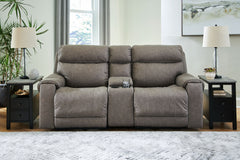 Destination: chic comfort. This power reclining loveseat with console launches your living room into superior form with stellar attention to detail. Exemplifying attainable luxury, its handsome hue has an air of sophistication youâ€™ll long to lounge in. 