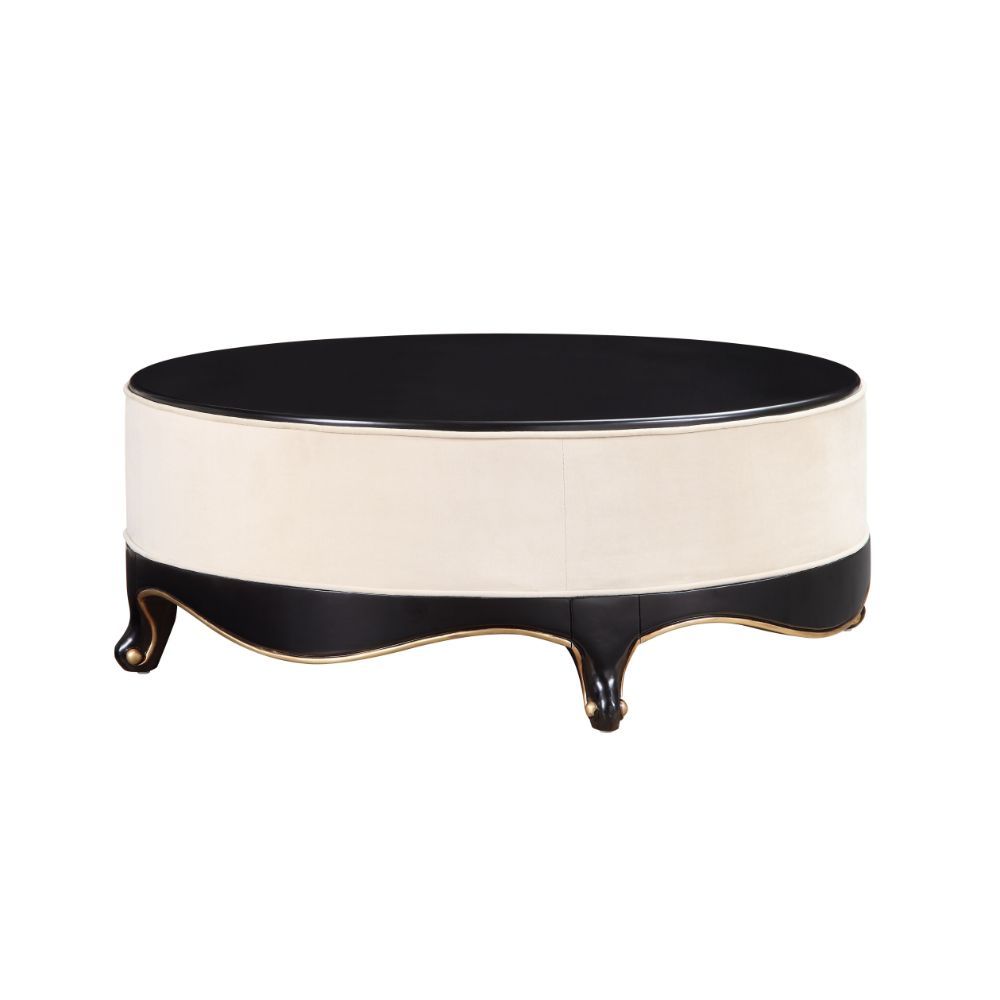 The Sheridan Cocktail Table is rich in detail and will make a statement in any living area. This classic round coffee table showcases a distinctive style for an intriguing look. Featuring a cream fabric upholstered frame with gorgeous scalloped apron and 