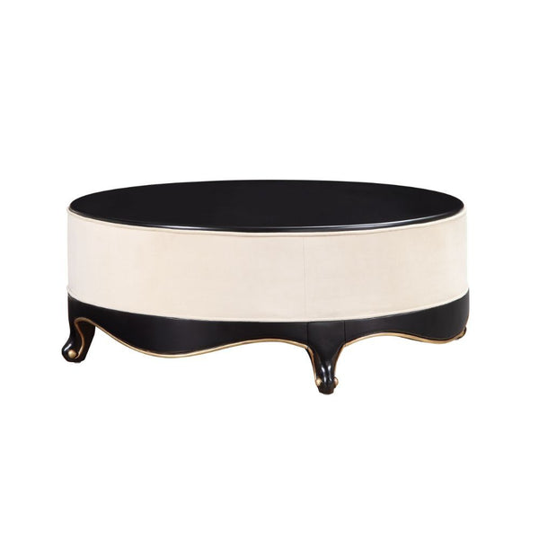 The Sheridan Cocktail Table is rich in detail and will make a statement in any living area. This classic round coffee table showcases a distinctive style for an intriguing look. Featuring a cream fabric upholstered frame with gorgeous scalloped apron and 