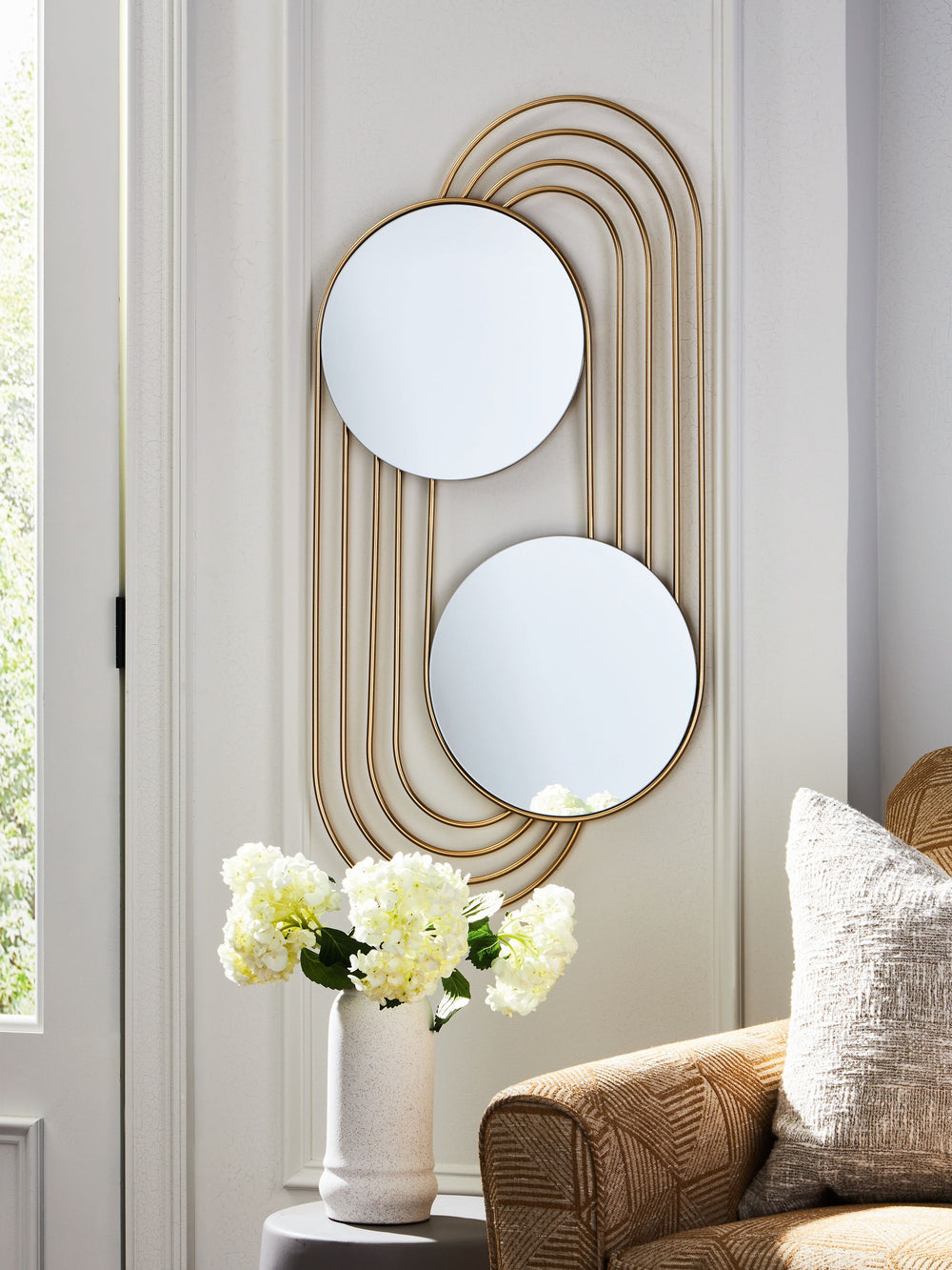 Look at youâ€”times two. If an ultra-contemporary look is the vibe you-'re going for, then this accent mirror is beautifully on point. A gracefully curved goldtone frame completes the design with a sense of subtle sophistication. What an eye-catching addi