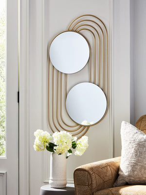  then this accent mirror is beautifully on point. A gracefully curved goldtone frame completes the design with a sense of subtle sophistication. What an eye-catching addi
