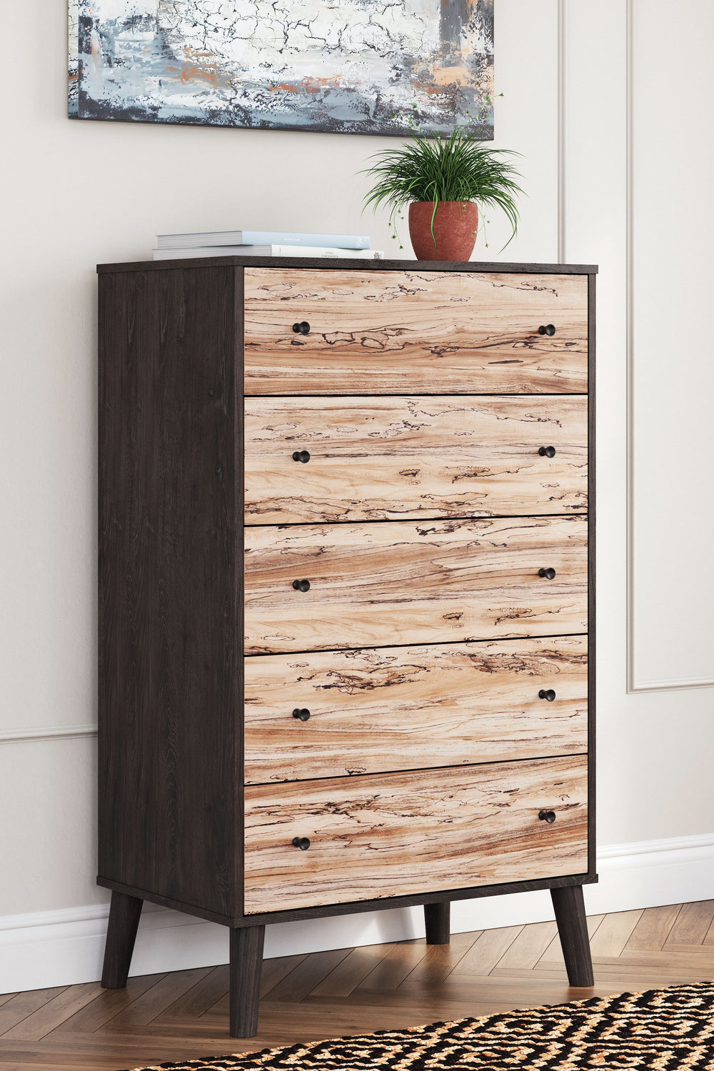 The perfect marriage of simple and contemporary style, this chest of drawers is a charming addition to your home. It features an expressive two-tone look, with a dark charcoal finish over replicated oak grain with an authentic touch and a replicated sugar