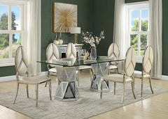 Shine and polish your dining room with pure glamour with the Noralie dining table. Tempered glass and mirrored panels create a sophisticated elegance while the faux diamonds add the perfect finishing touch to this luxurious dining set. Rest upon tufted ch