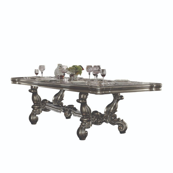 Irresistibly inviting, the Versailles collection displays the unrivaled beauty of the traditional dining. The dining table reflects highly decorative base with oversized scrolled feet, and the upholstered and tapestried chairs with Nailhead trim accents a