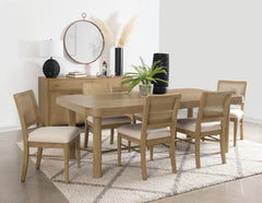 This dining set blends modern craftsmanship with natural textures for a refined yet inviting feel. The dining table features a trestle base with an antique brass-finished metal stretcher bar, adding stability and contrast. Rounded corners soften the recta