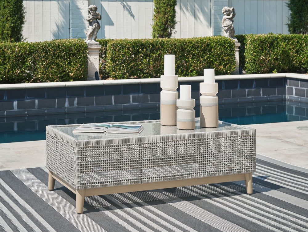 This coffee table invites your casual contemporary style outdoors. With its resin wicker in a chic neutral hue, it expertly marries refined design with durability. Breezy summer mornings and cold winter nights are made all the more enjoyable with a glass 
