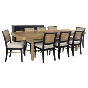 This dining set blends modern craftsmanship with natural textures for a refined yet inviting feel. The dining table features a trestle base with an antique brass-finished metal stretcher bar, adding stability and contrast. Rounded corners soften the recta