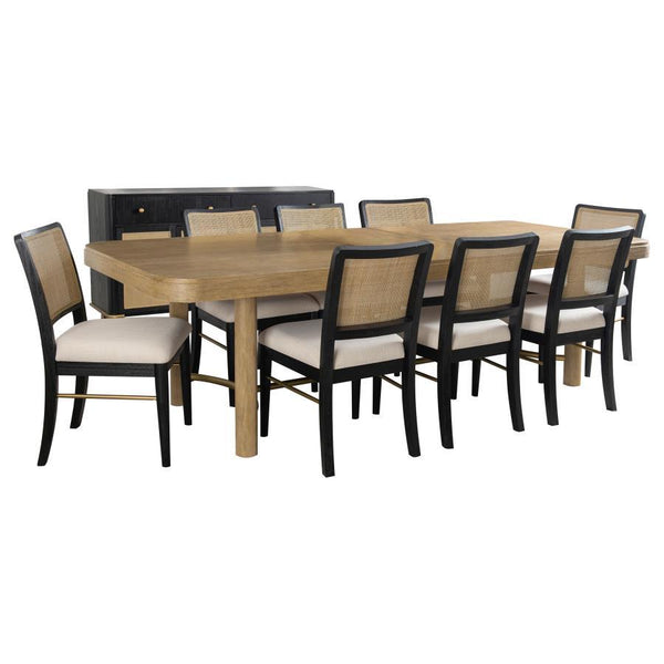 This dining set blends modern craftsmanship with natural textures for a refined yet inviting feel. The dining table features a trestle base with an antique brass-finished metal stretcher bar, adding stability and contrast. Rounded corners soften the recta