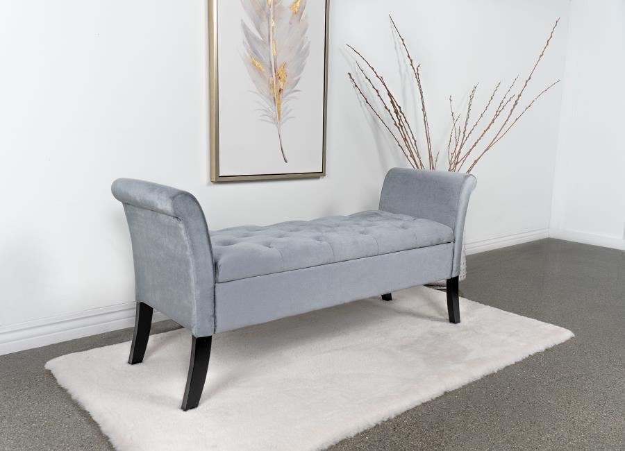 Elevate your living space with a harmonious blend of luxury and utility found in this exquisite storage bench. Adorned with a plush velvet upholstery, it boasts flared arms and meticulous button-tufting, reflecting a dedication to design and attention to 