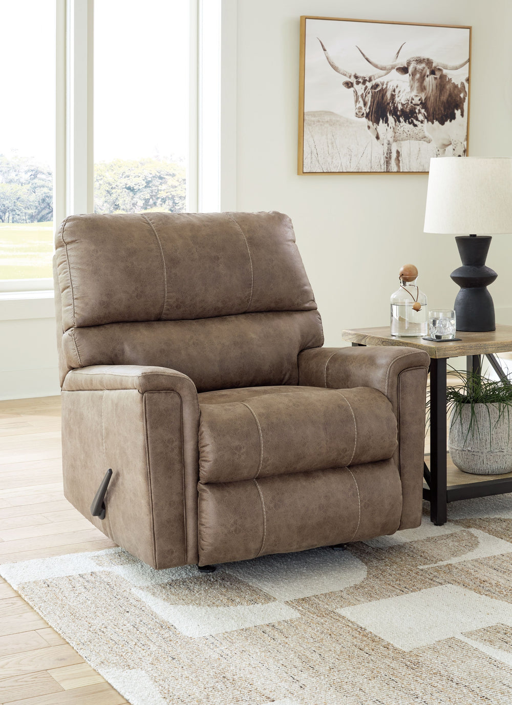 This decidedly modern recliner proves less is more, bringing simply inviting style to your living room. Take the guesswork out of decoratingâ€”its warm faux leather has a universal appeal, pairing with casual and contemporary aesthetics alike. And with th