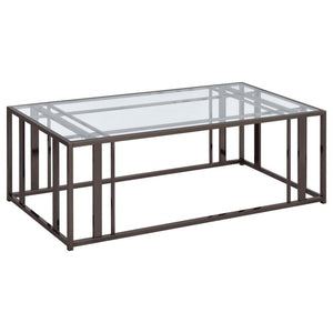 This modern rectangular coffee table features a clear tempered glass top paired with a geometric base made from heavy-gauge metal with a sleek electroplated finish. The open design offers a contemporary aesthetic, blending elegance with durability. Perfec