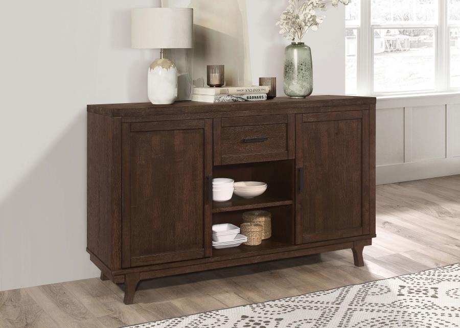 Enhance your dining area with our farmhouse and craftsman design dining server. Crafted from solid Asian hardwood, this server features a durable wire brushed brown oak finish, adding a rustic touch to your dÃ©cor. It offers functionality with its two doo