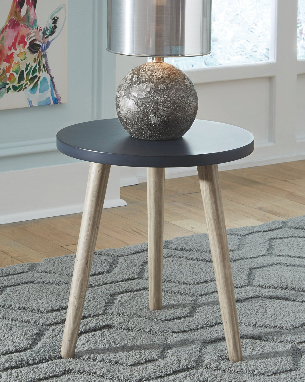 This small side table has a blue circular top and three light tan wooden legs. It-'s ideal as a bedside table or lamp table in your living areas, bringing casual elegance to your home.<br/><br/><b>Product Features</b><ul><li>Wood, veneer and engineered wo