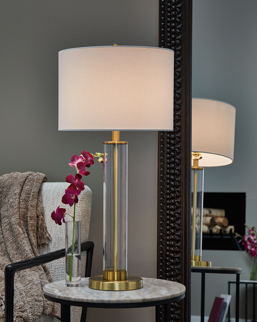 The body of this elegant table lamp has a contemporary flair, with a transparent glass cylinder that reveals a brass-tone rod inside. It-'s a minimal design made for maximal illumination.<br><br><b>Additional Dimensions</b><br><ul><li>Shade: 0-"</li><li>C
