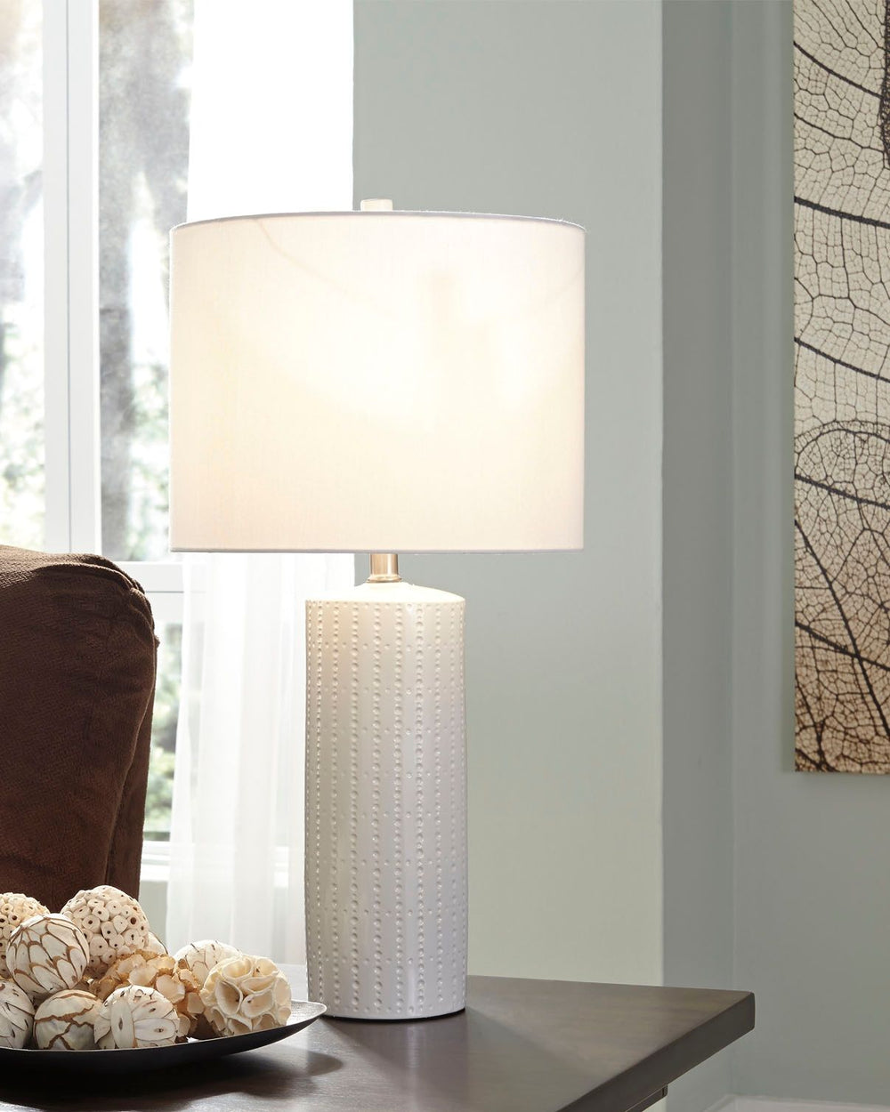 Its base teeming with texture, this ceramic table lamp proves that a monochromatic design can still be visually interesting. The clean lines and crisp finish are quintessential contemporary.<br><br><b>Additional Dimensions</b><br><ul><li>Shade: 0-"</li><l
