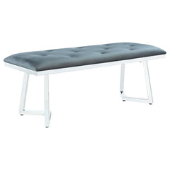 Add a sophisticated edge to your dining space with this contemporary velvet dining bench. Upholstered in plush grey velvet with button tufting, it offers a soft and inviting seat. The polished stainless steel base boasts a striking angular frame, deliveri