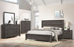 This bedroom set is the embodiment of understated sophistication, featuring a muted gray finish that complements its clean and contemporary design. The robust bed frame anchors the room with a sense of sturdiness and style. Accompanying the bed are coordi