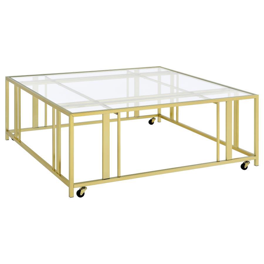 This square coffee table combines functionality with modern style, featuring a tempered glass top and a sturdy geometric base made from heavy-gauge metal. The open-frame design creates a sleek, contemporary look, while smooth-rolling casters add mobility 