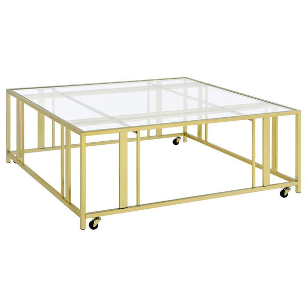 This square coffee table combines functionality with modern style, featuring a tempered glass top and a sturdy geometric base made from heavy-gauge metal. The open-frame design creates a sleek, contemporary look, while smooth-rolling casters add mobility 
