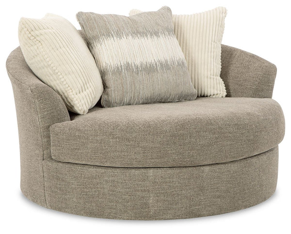 Easy on the eyes, this oversized swivel accent chair rounds out your seating options with ease. Its generous scale cradles you in comfort, while the swivel feature lets you go with the flow. A collection of coordinating accent pillows adds to the indulgen