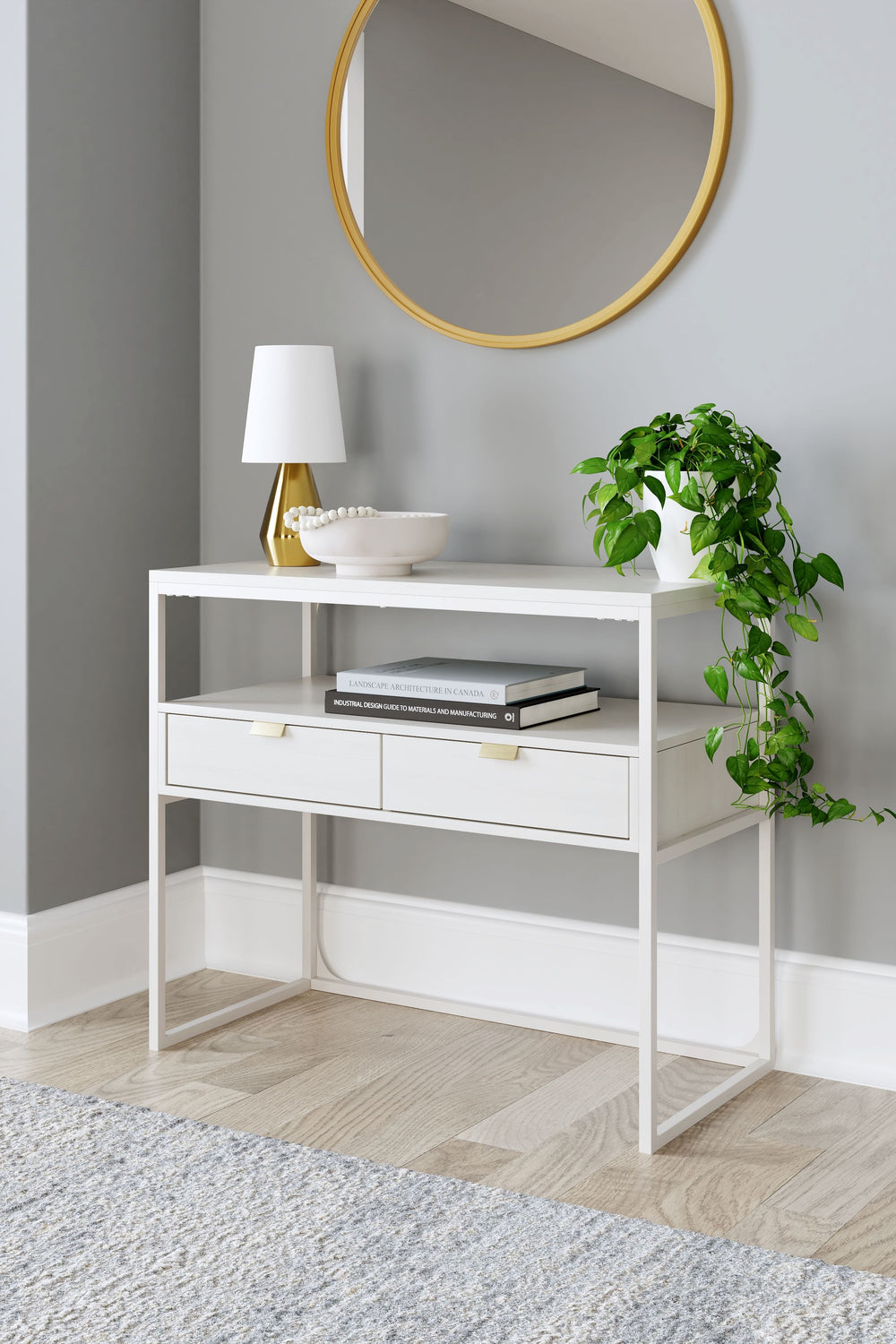 Bring your vision of a modern home workspace to life with this sleekly designed credenza. Its linear construction and white finish keep things minimal, while goldtone hardware on the two drawers adds subtle refinement. An open shelf rounds out the versati
