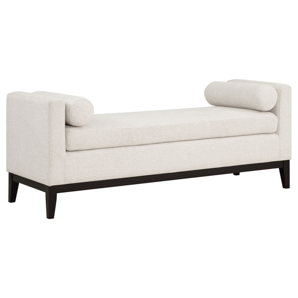Complete a stylish, sophisticated living area or master suite with a modern upholstered bench. The backless design includes straight track arms, setting an austere silhouette. A pair of round bolster pillows soften the look and offer impeccable comfort an