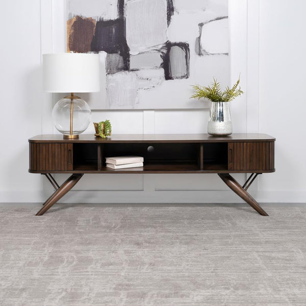 As the centerpiece of any sophisticated living room, this 71" TV stand, with its mid-century modern design, brings a touch of elegance and timeless charm. Its sleek silhouette is perfectly complemented by the rich walnut finish, offering a warm, inviting 