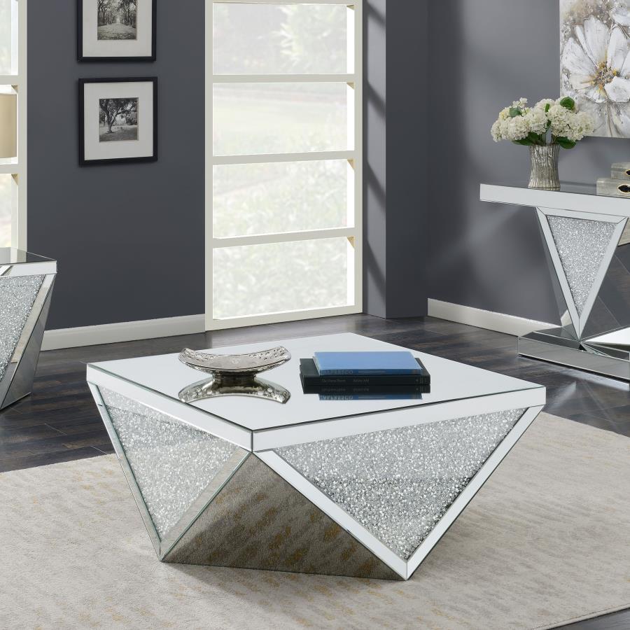 Amplify the style of your living room with this mirrored coffee table. Its bold, diamond-shaped base features triangular mirrored panels with alternating glittery material, adding shimmering sparkle and opulent style. A 40-inch square, reflective surface 