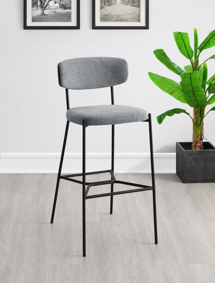 Create a relaxed and inviting ambiance at a kitchen bar or in your home lounge with a set of two modern barstools. Each boasts a durable and strong metal frame with a sandy black finish. Dark oak finish backrests complement neutral upholstery, offering fo