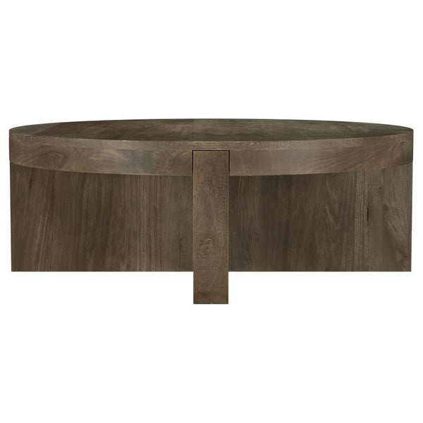 Center your living space around the striking, solid profile of a modern wooden coffee table. Crafted in exquisite mango wood, the table receives a dark brown finish to ensure standout style. The round cocktail table is a low, inviting centerpiece for your