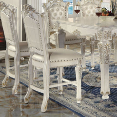 KD, Armless Chair Padded Seat & Back Cushion: PU with Nailhead Trim (Button Tufted Inside Backrest) Wooden Seat Apron with Molding Trim Wooden Tapered Leg & Footrest Supports: Floral Motif