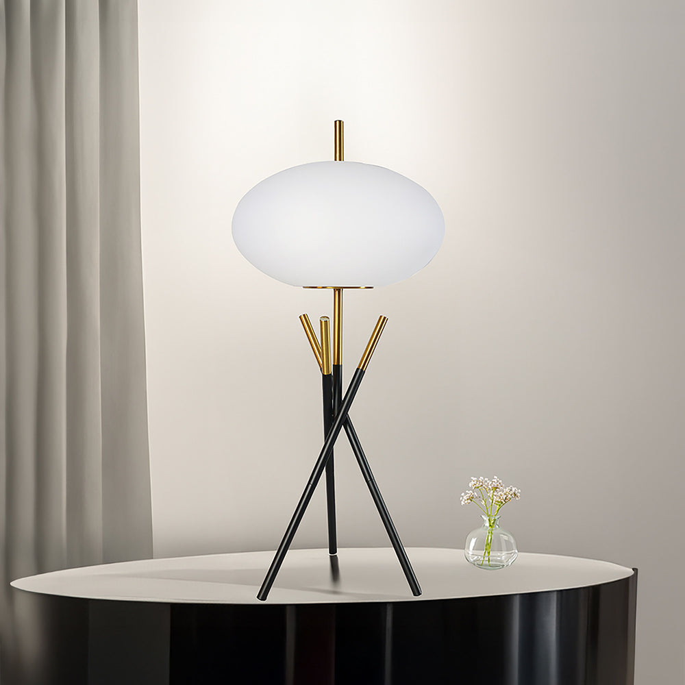 Transform your space with this bold and artistic lighting solution that seamlessly fuses minimalism with modern luxury. Featuring a sleek, tripod-style base in a striking black and gold finish, this lamp exudes a refined elegance. Its centerpiece is a smo