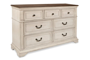 Complete your bedroom with the New Classic Furniture Anastasia 7 Drawer Dresser, a testament to real wood craftsmanship with solid poplar and oak veneer for enduring durability. The heirloom finish, achieved through a meticulous multi-step process involvi