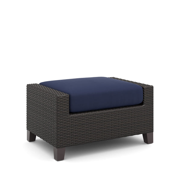 The Skye Outdoor Ottoman Set in rich Navy Blue includes 2 cushioned ottomans and is crafted with durable aluminum frames and a baked-on powder finish to ensure longevity and scratch resistance. The high-density HDPE wicker mimics the look of natural wicke