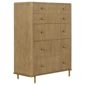 This charming mid-century, modern, five-drawer chest offers a gorgeous contemporary glam look with its softly rounded corners and aged brass metal hardware. A neutral sand wash wood tone with a wire-brushed finish adds texture and warmth to bedrooms. Clev