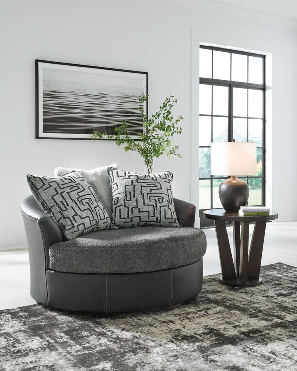  it pairs cozy fabric with faux leather for invitingly cool character. And with its robust size offering extra seating space