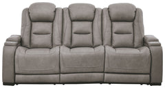 Reserved for him and made for her, this power reclining sofa in gray delivers all the comfort and style you could ask for. Inspired by sports car interiors, the expertly matched leather and faux leather upholstery has a â€œperforated automotiveâ€ treatme