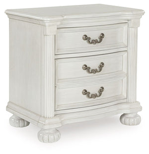 Transform your inner sanctum into a haven of timeless elegance and functionality. This traditionally styled nightstand is adorned in a classic antiqued white finish, highlighted by a serpentine-shaped front with thick decorative moulding. Its drawers are 