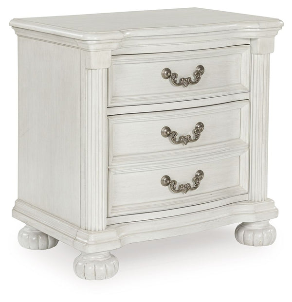 Transform your inner sanctum into a haven of timeless elegance and functionality. This traditionally styled nightstand is adorned in a classic antiqued white finish, highlighted by a serpentine-shaped front with thick decorative moulding. Its drawers are 