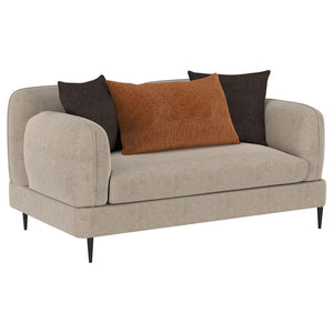 The loveseat blends chic architectural elements with cozy sophistication, wrapped in latte chenille upholstery for a soft, textured feel. Its rounded, sculpted track arms and matching back provide a harmonious design, accented by a sleek waterfall bench s