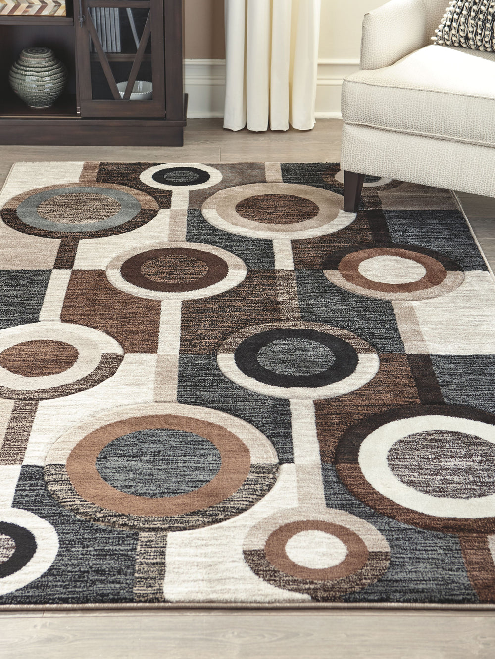 Talk about bringing modern pop to a space. With its multilayered geometric design and pleasing palette of black, brown and cream tones, this area rug is decidedly bold without coming on too strong.<br/><br/><b>Product Features</b><ul><li>Made of polypropy