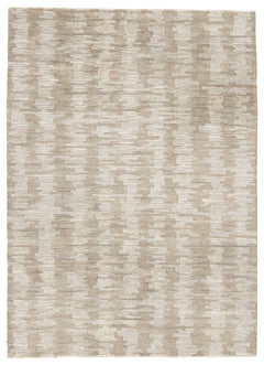 The hand-tufted modern design of this area rug will make a bold statement in any room. By alternating the pattern flow, the weavers have created a work of art alive with texture. Shades of cream and brown are blended to produce an abstract-yet-tranquil fe