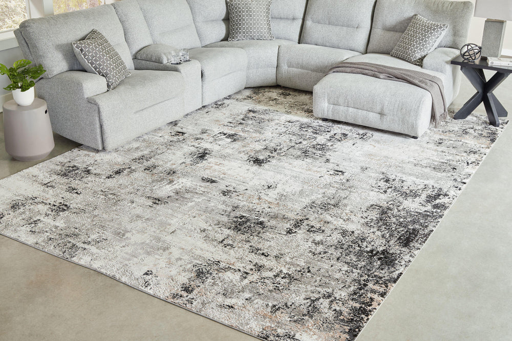 Wonderfully versatile and richly understated, this area rug brings plush comfort and a highly contemporary point of view to your decor. Incorporating so much visual texture, the abstract black, gray, white and tan design is a masterpiece of subtlety. Itâ€