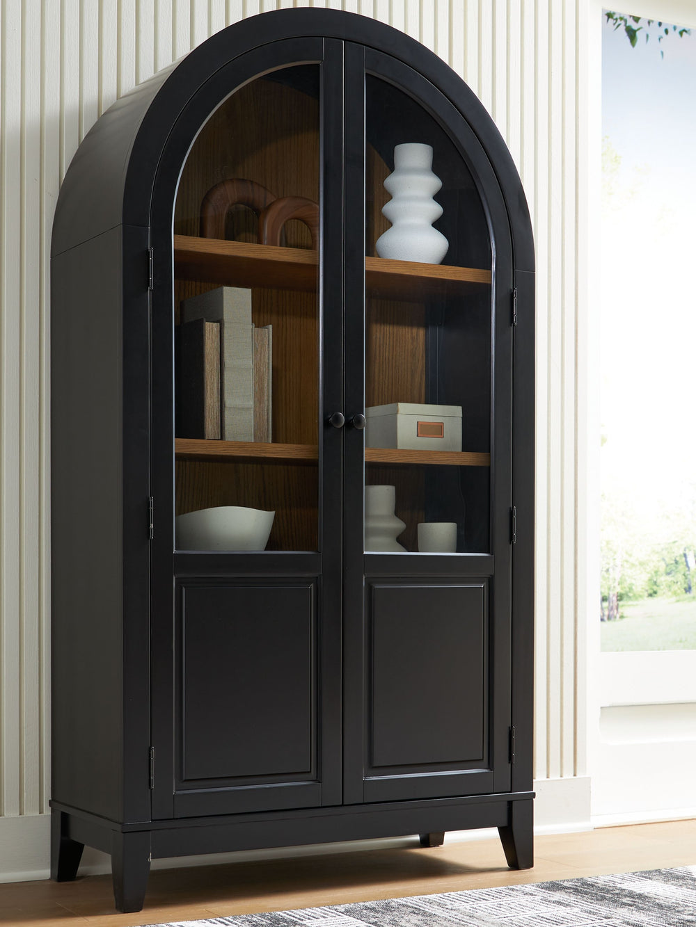 This accent cabinet is proof positive that style and storage can go hand in hand. Doors with glass fronts invite you to create a charmingly curated display of your favorite china and decor pieces. And the cool curves of its arched design add an inviting a