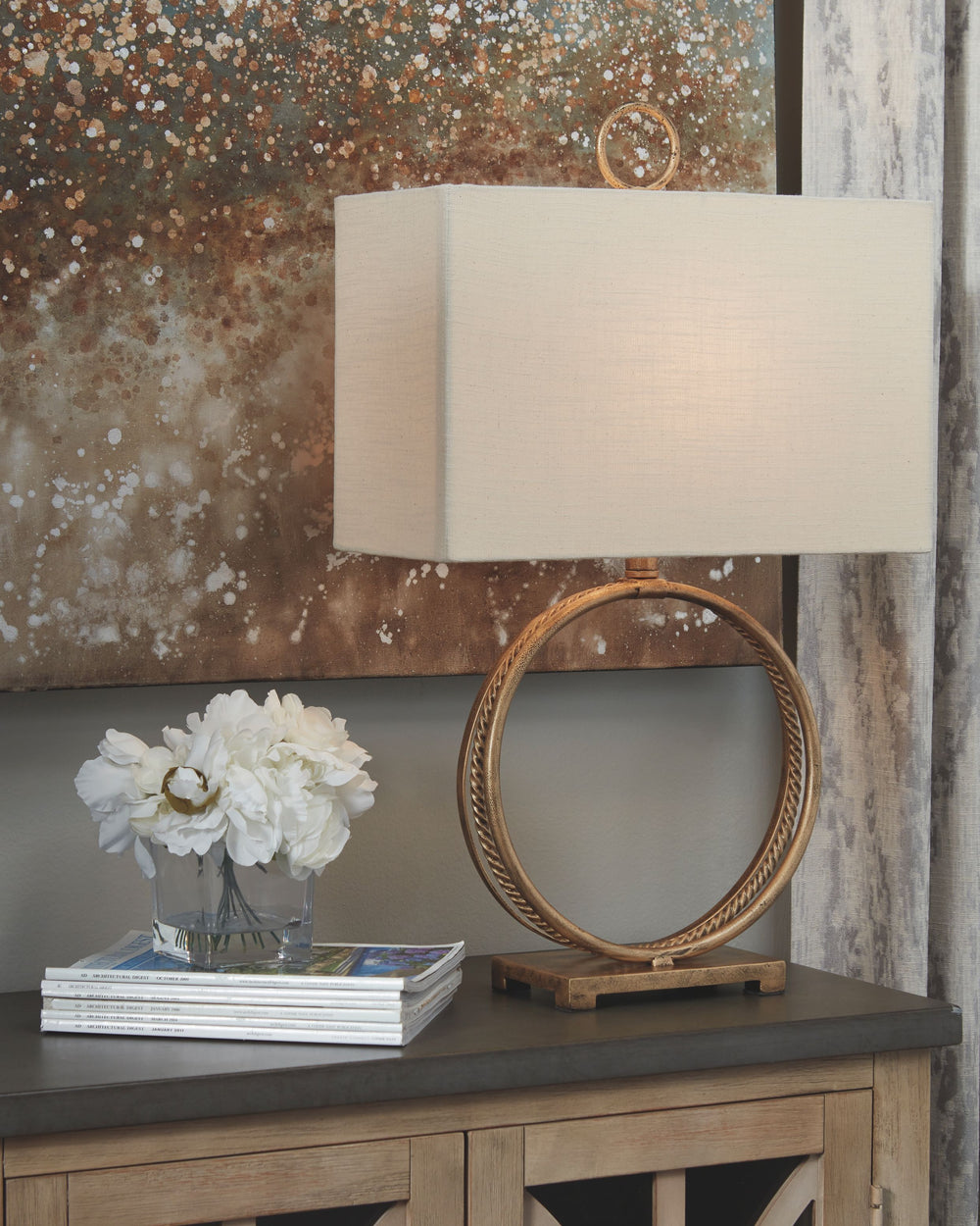 Thereâ€™s something so elegant about this table lamp-'s rounded shape. Goldtone braided metal punctuates the less-is-more base for that touch of high drama lighting you crave.<br><br><b>Additional Dimensions</b><br><ul><li>Shade: 0-"</li><li>Base: 0-"</li