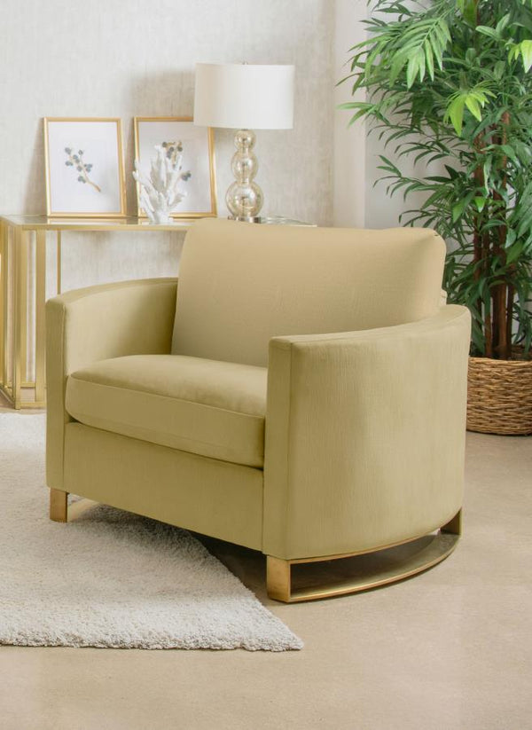  complemented by curved arms and gold stainless steel legs. Smooth upholstery and lustrous details blend simplicity with timeless splendor